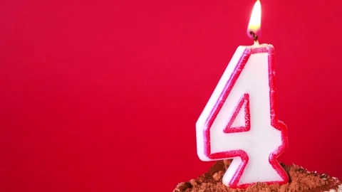 Celebrating fourth birthday with cake and candles in a vibrant atmosphere Vídeos de archivo 295191253