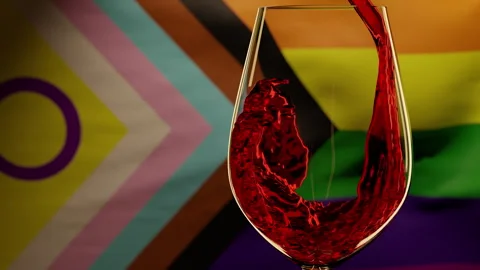 Celebrating Pride Month with Red Wine pouring against LGBTQ flag Stock Footage 241900548