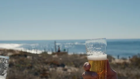 Celebration beer cheers concept - close up hands holding up glasses of beer of Stock Footage
