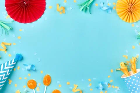 Celebration pattern with various party confetti on blue background. Flat lay Stock Photos
