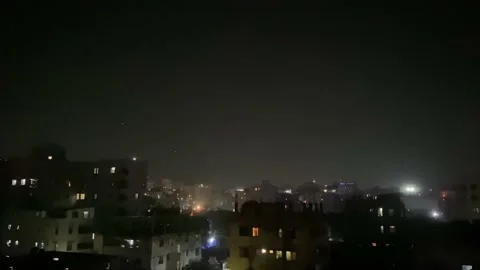 Celebratory Fireworks Exploding In the Night Sky Over Buildings. Locked Off Video stock 169143755