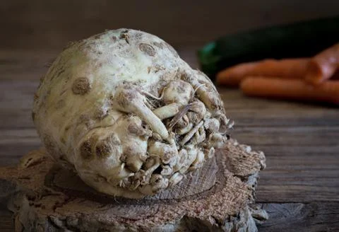 Celeriac on wooden table Stock Photos