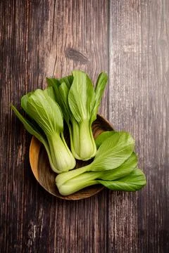 Celery cabbage or peach choi, asian baby salad leaves on wooden background Stock Photos