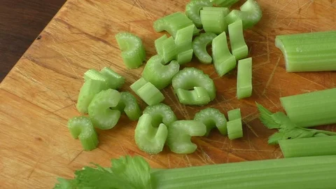 Celery chopped on wooden cutting board Stock Footage