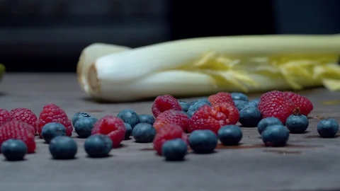 Celery, raspberries, blueberries on the table Stock Footage 127620156