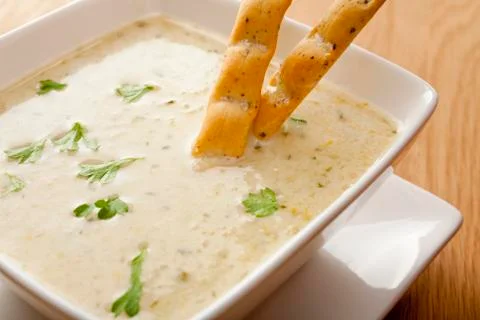 Celery soup with breadsticks Stock Photos