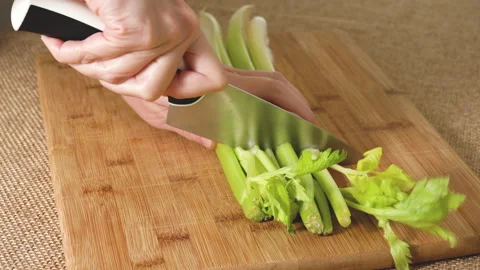 Celery stalk and potatoes close-up on wooden board. Stock Footage 224117904
