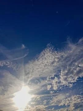 Celestial Canvas: A clear blue sky adorned with fluffy white clouds Stock Photos