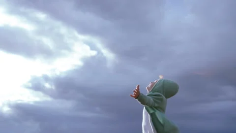 Celestial Harmony: Boy Interacting with Natures Elements Wind, Sunlight, and Stock Footage 317762946