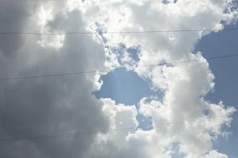 Celestial landscape. Thin wires against cloudy sky. Stock Photos