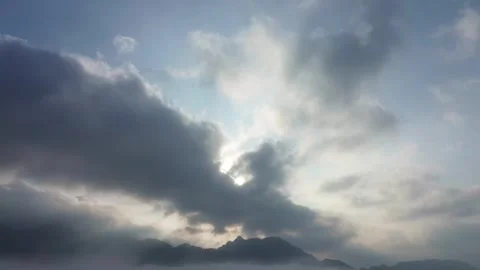 Celestial luminescence streams through ethereal mountain mists, painting a .. Video stock 337278679