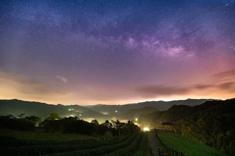 Celestial Symphony of Spring: Milky Way Sky with Rolling Clouds. Stock Photos