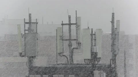 Cell antenna tower infrastructure with blizzard of snow falling Stock-Footage 165248999