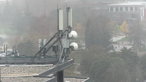Cell antenna tower infrastructure with snow falling Stock Footage 164416123