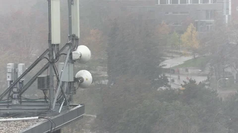 Cell antenna tower infrastructure with snow falling Stock Footage 164416306