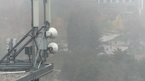 Cell antenna tower infrastructure with snow falling Stock-Footage 164416555