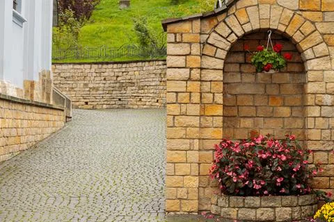 Cell element street decorative object with flower pot in cobble stone stree.. Stock Photos