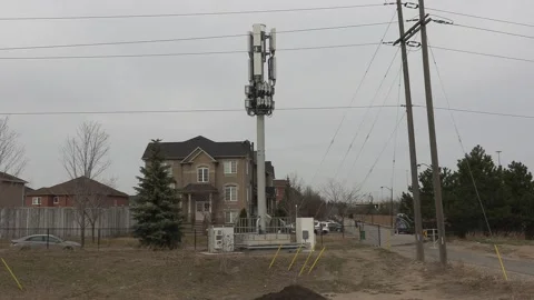 Cell phone and communications tower next to residential houses Stock Footage 151058137