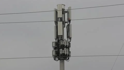 Cell phone and communications tower next to residential houses 動画素材 151058186