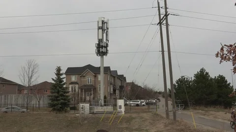 Cell phone and communications tower next to residential houses Stock Footage 151058251
