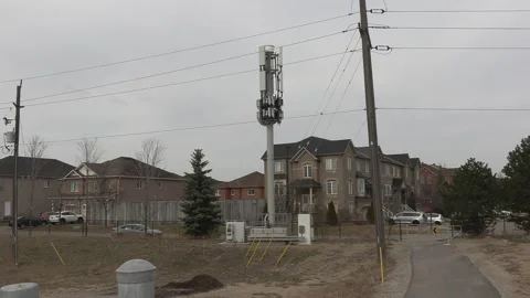 Cell phone and communications tower next to residential houses Stock Footage 151058544