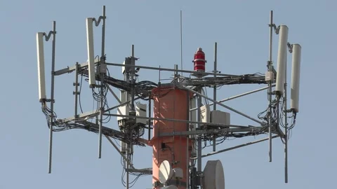 Cell phone and communications tower with radio antennas on it Video stock 151663498