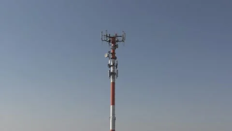 Cell phone and communications tower with radio antennas on it Видео 151664017