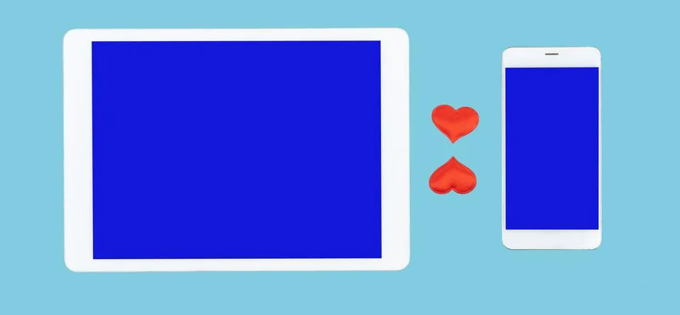 Cell phone and tablet computer on blue background. red hearts between gadgets Stock Illustration