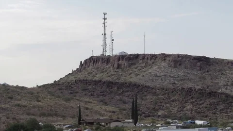 Cell phone antenna tower sits high on a canyon mountain ridge in Kingman Arizona Stock Footage 80179696