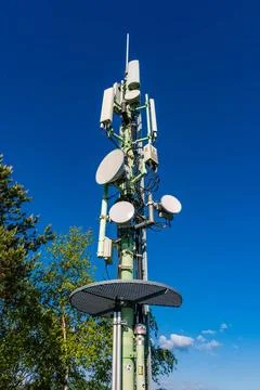 A cell phone base station mast with antennas and reflectors Pirna Saxony G... Stock Photos