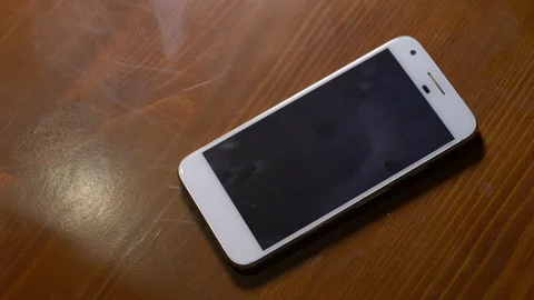 Cell phone being grabbed from the table Stock Footage 124868169