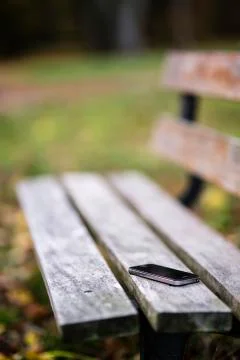 Cell phone on a bench Stock Photos