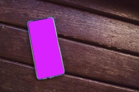 Cell phone blank white screen mockup. texting using mobile on desk at office. Stock Photos