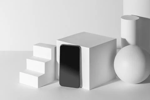 Cell phone with empty screen among white 3d paper shapes with copy space Stock Illustration