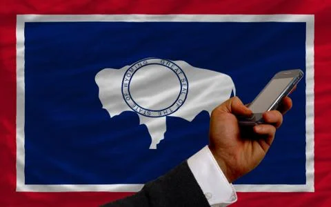 Cell phone in front  flag of american state of wyoming Stock Photos