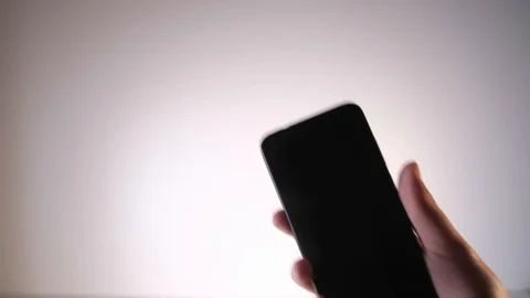 Cell phone in hand on white background with chroma key Video stock 130067928