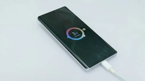 Cell phone, only at 3% battery, is charging. Stock Footage 330035915