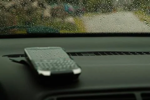 Cell phone placed on a dashboard captured in very shallow depth of field Stock Photos