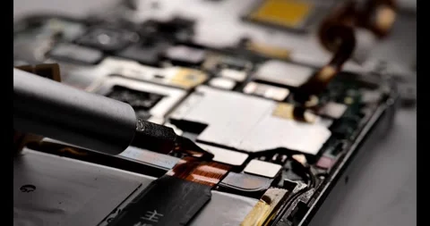 Cell phone repair: How to replace a phone battery. Stock Footage 274093725