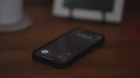 Cell phone ringing on table in the evening by an unknown caller Stock Footage 306696039