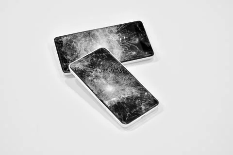 Cell phone with the screen broken by a hammer. Stock Photos