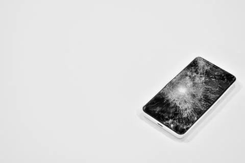 Cell phone with the screen broken by a hammer. Stock Photos