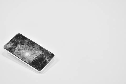 Cell phone with the screen broken by a hammer. Stock Photos