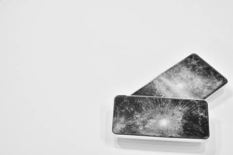 Cell phone with the screen broken by a hammer. Stock Photos