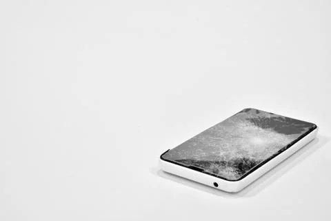 Cell phone with the screen broken by a hammer. Stock Photos