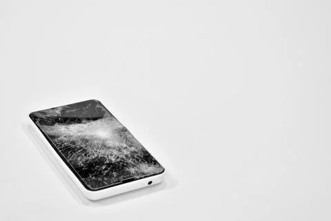 Cell phone with the screen broken by a hammer. Stock Photos