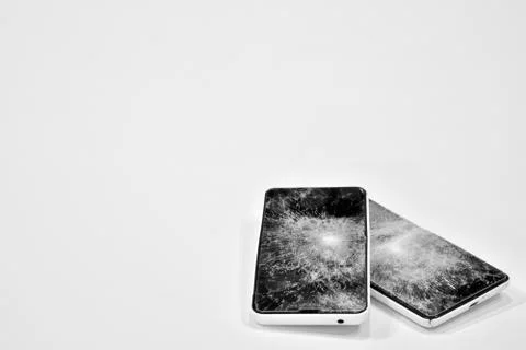 Cell phone with the screen broken by a hammer. Stock Photos