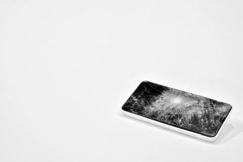 Cell phone with the screen broken by a hammer. Stock Photos
