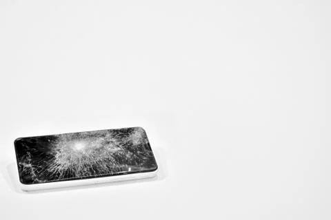 Cell phone with the screen broken by a hammer. Stock Photos