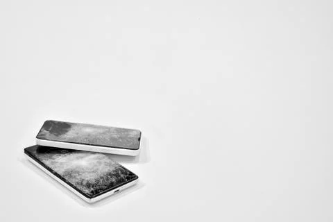 Cell phone with the screen broken by a hammer. Stock Photos